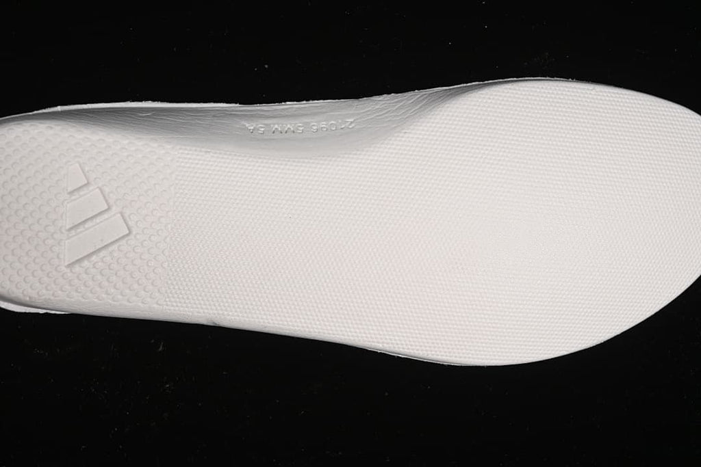 Close-up of the light-colored outsole and adidas logo.
