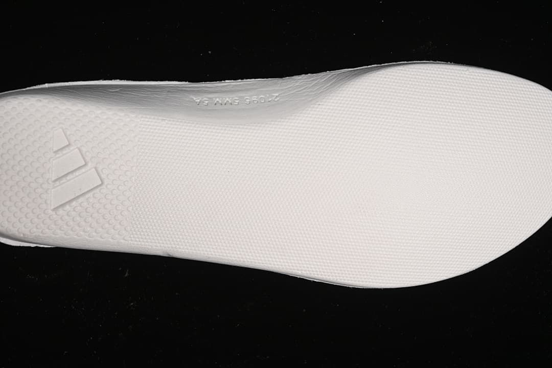 Close-up of the light-colored outsole and adidas logo.