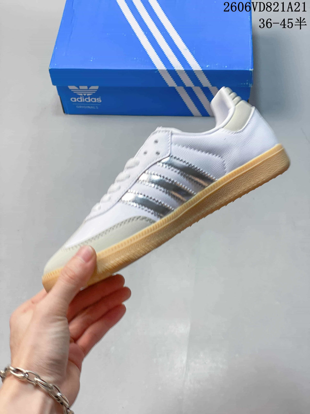 Side view of a white adidas Samba sneaker with silver-tone stripes and a gum-colored outsole.