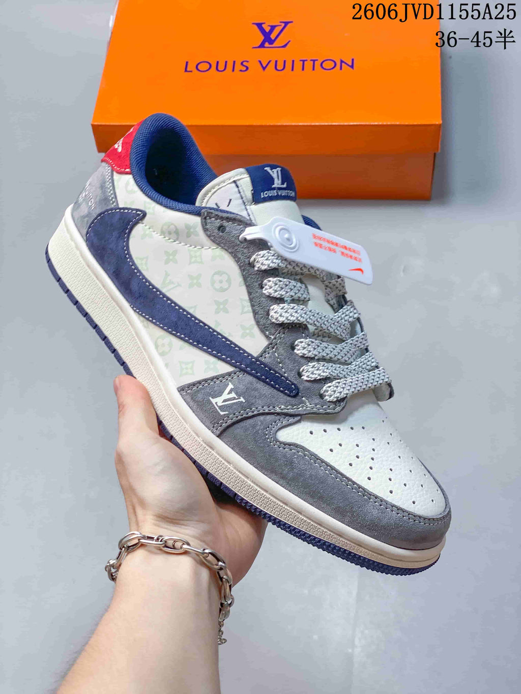 Close view of a gray and white low-top sneaker with navy overlays and patterned side panels