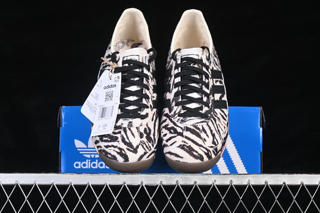 Front view of the pair displayed on a blue adidas box.