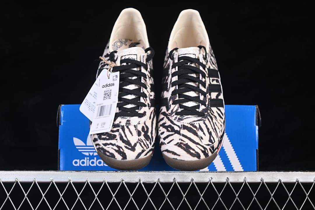 Front view of the pair displayed on a blue adidas box.