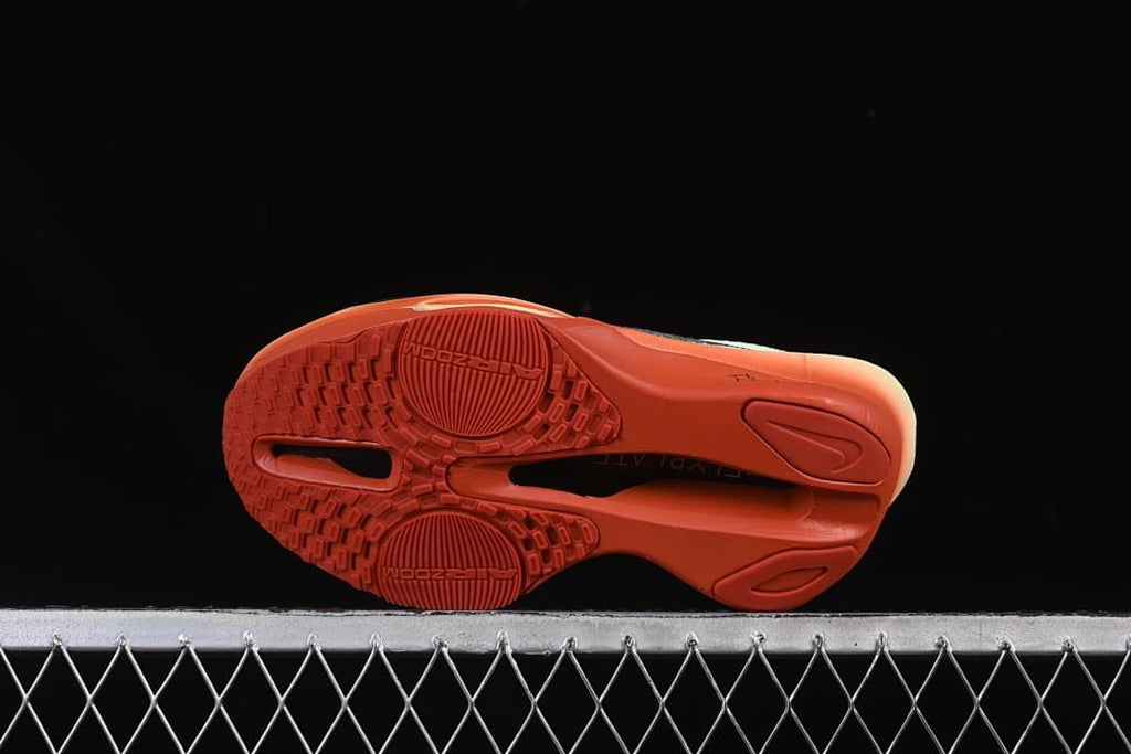 Underside view showing the coral-orange tread