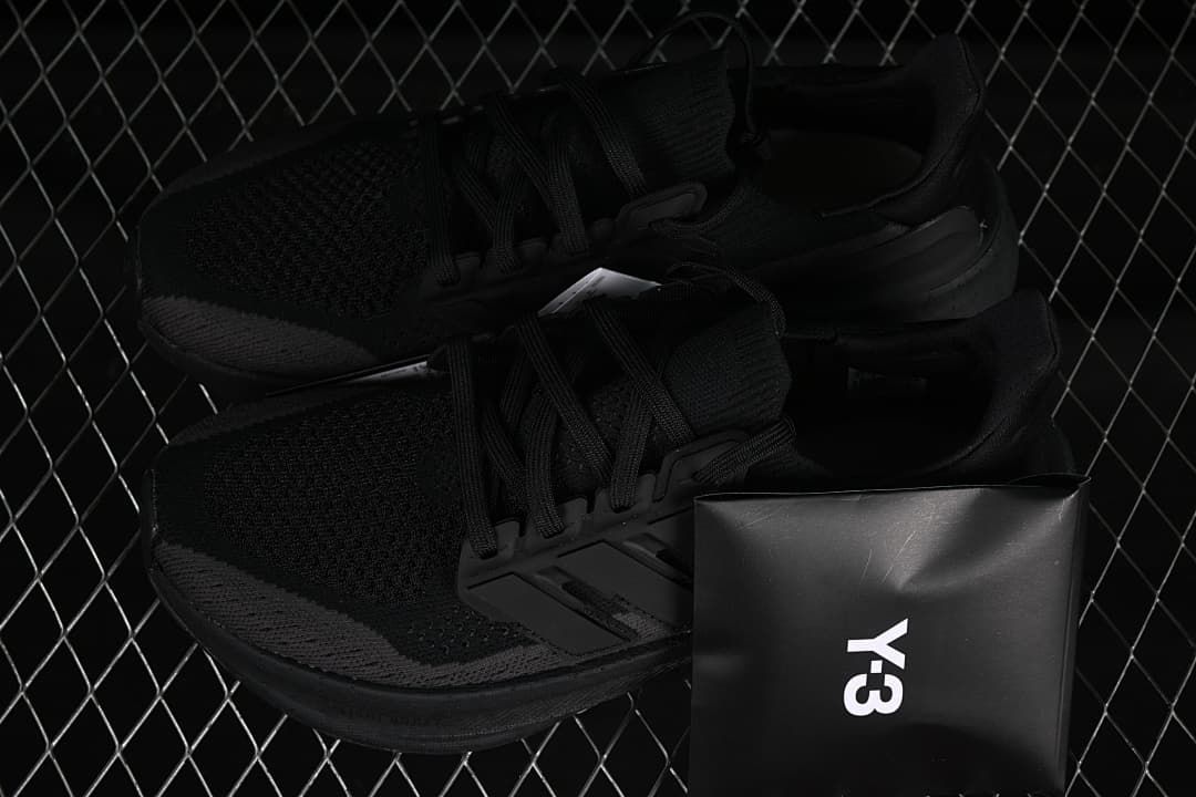 Pair of black sneakers displayed with a Y-3 box