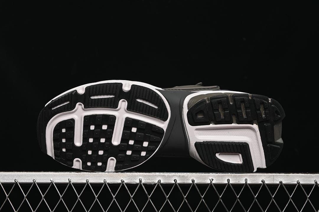 Underside view showing the patterned black, white, and brown outsole