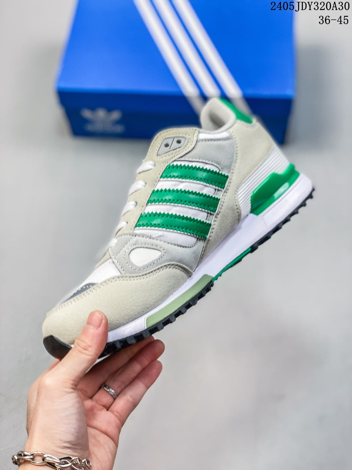 Side view of a white and green Adidas ZX 750 sneaker with three-stripe detailing