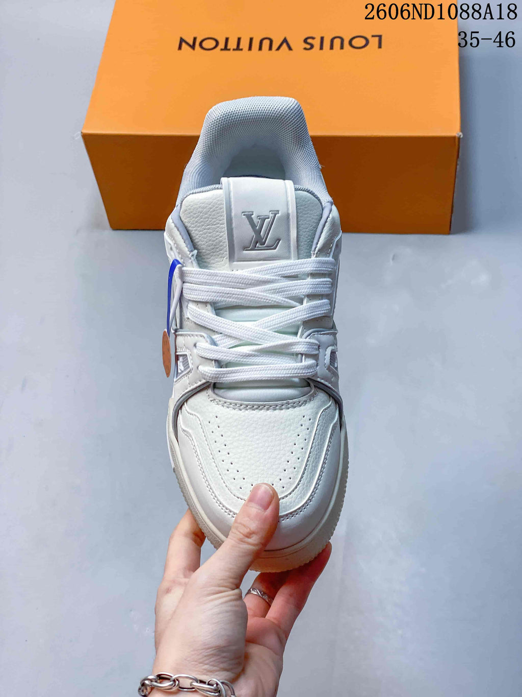 Top view showing the laces, perforated toe, and tongue logo on a white sneaker
