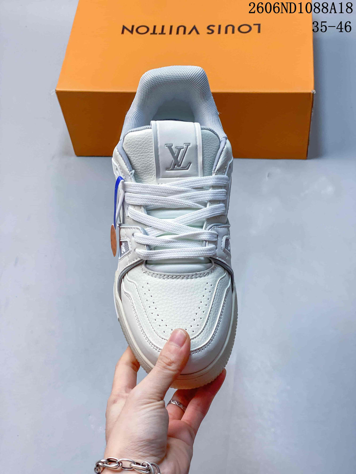 Top view showing the laces, perforated toe, and tongue logo on a white sneaker