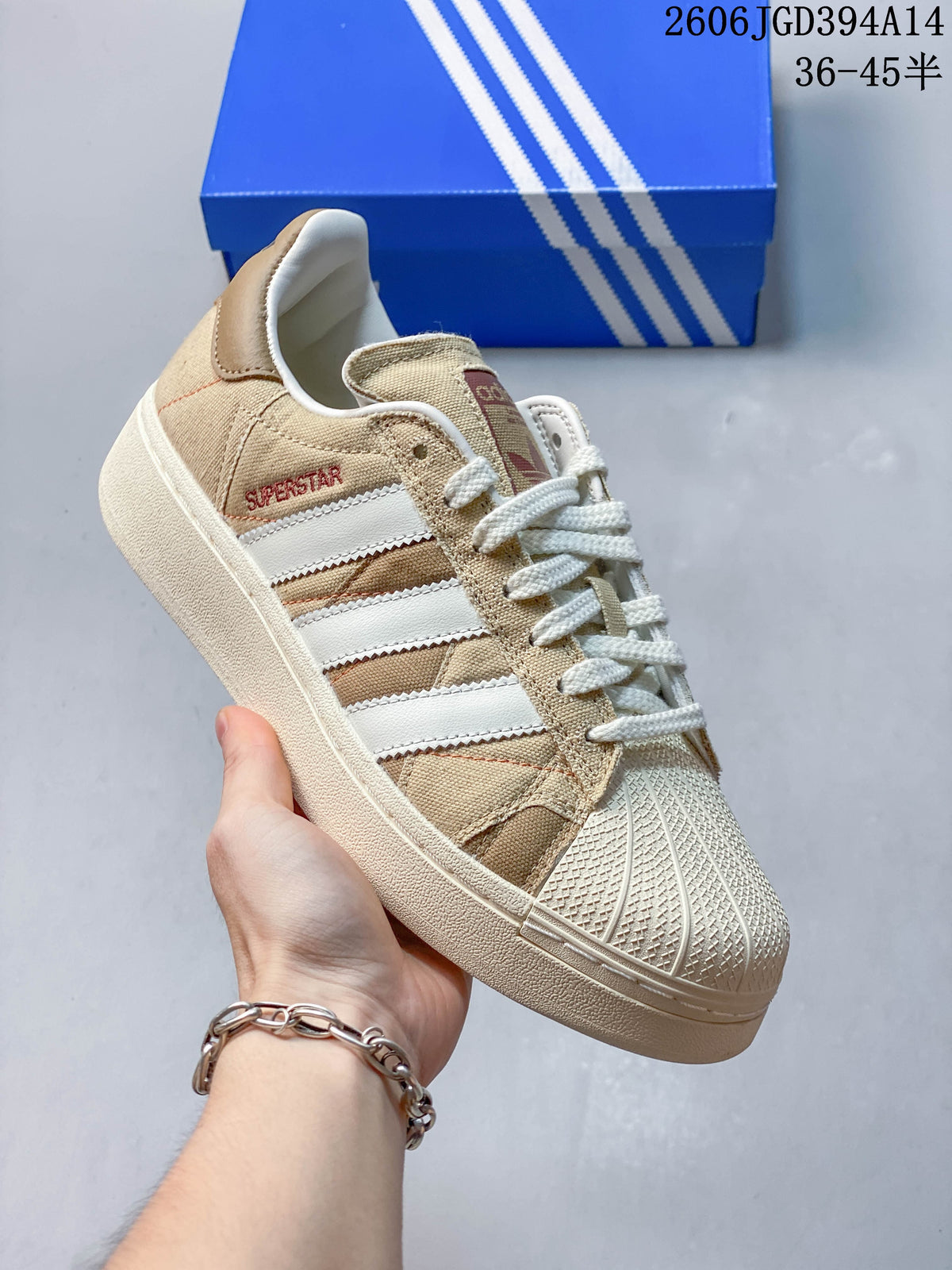 Angled close-up of the beige and white Superstar sneaker