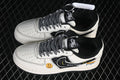 Pair of white and black low-top sneakers with patterned side panels and graphic details