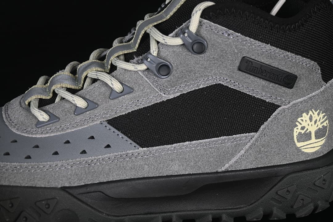 Detail of the grey side panels, black insert, laces, and Timberland tree logo.