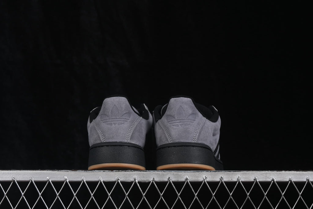 Rear view showing the grey heel panels, Adidas trefoil details, black midsoles, and gum-colored outsole edges.
