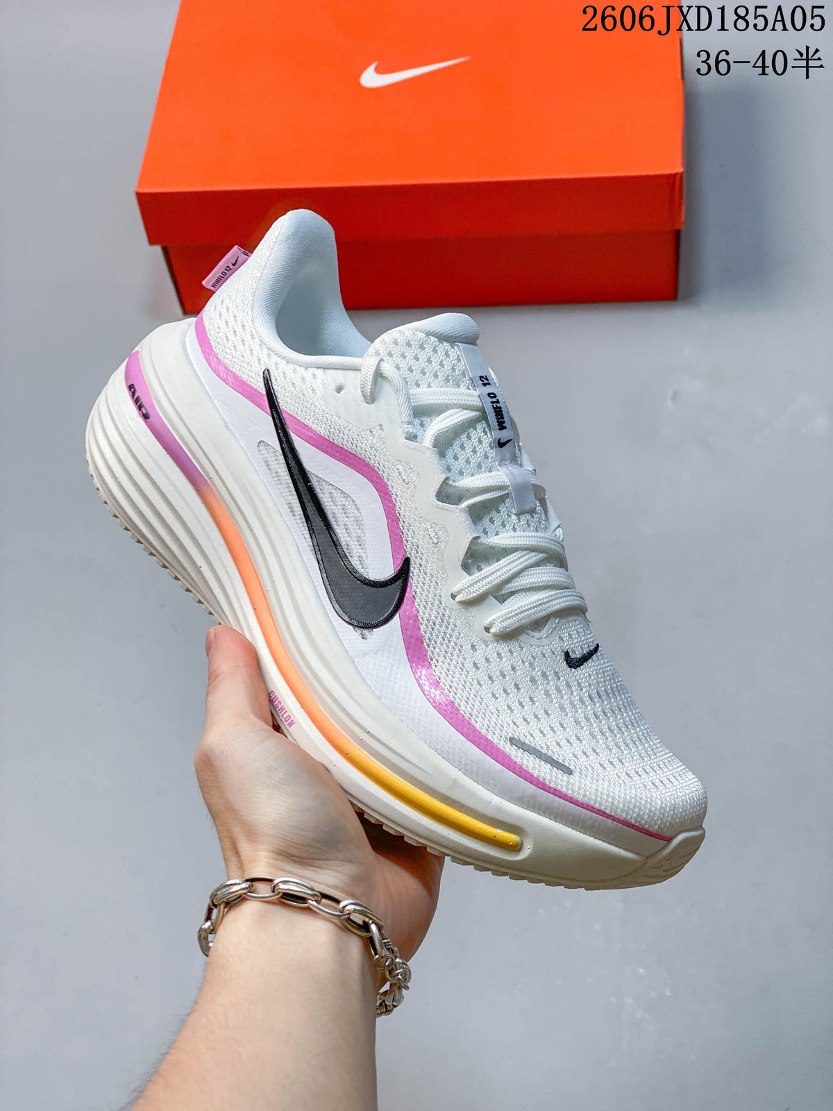 Side view of a white Nike Winflo 12 running shoe with pink and orange accents.