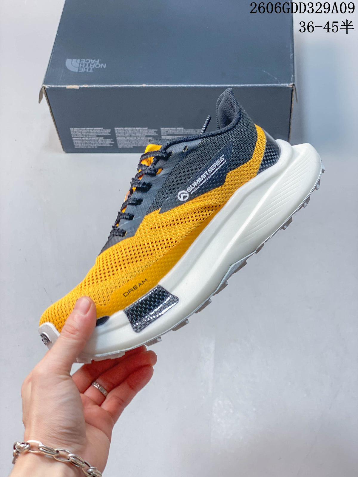 Side view of a yellow and dark gray VECTIV hiking shoe with a white midsole.