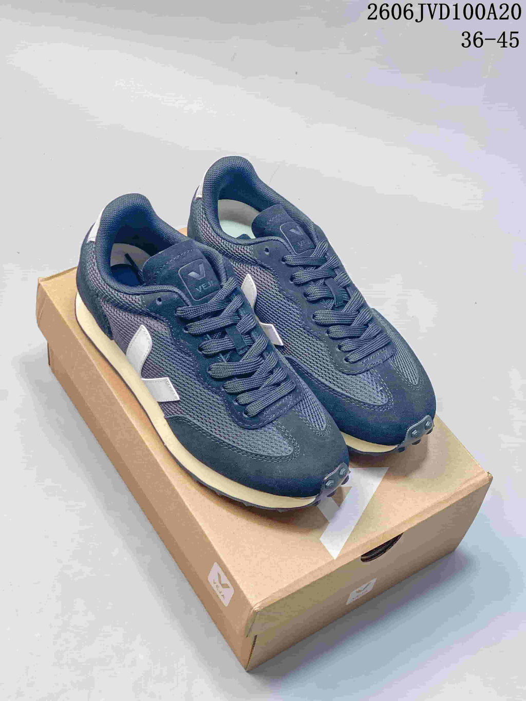 Dark navy low-top sneakers with contrasting light side logos