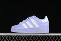 Side view of lavender Adidas Superstar XLG sneakers with white stripes and a platform-style sole