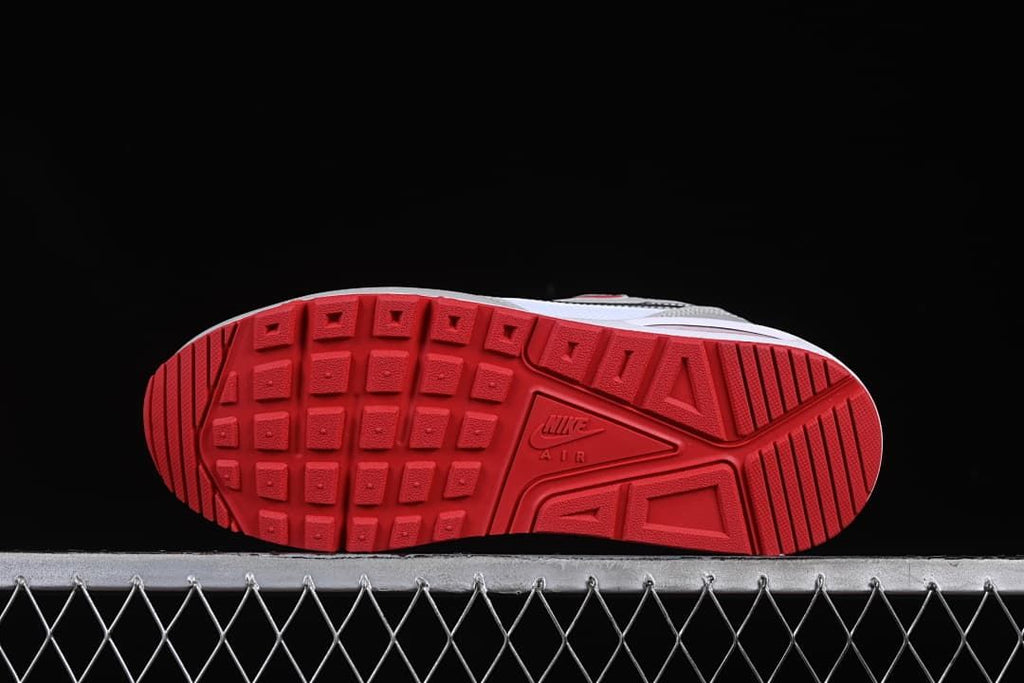 Underside view showing the red patterned outsoles.