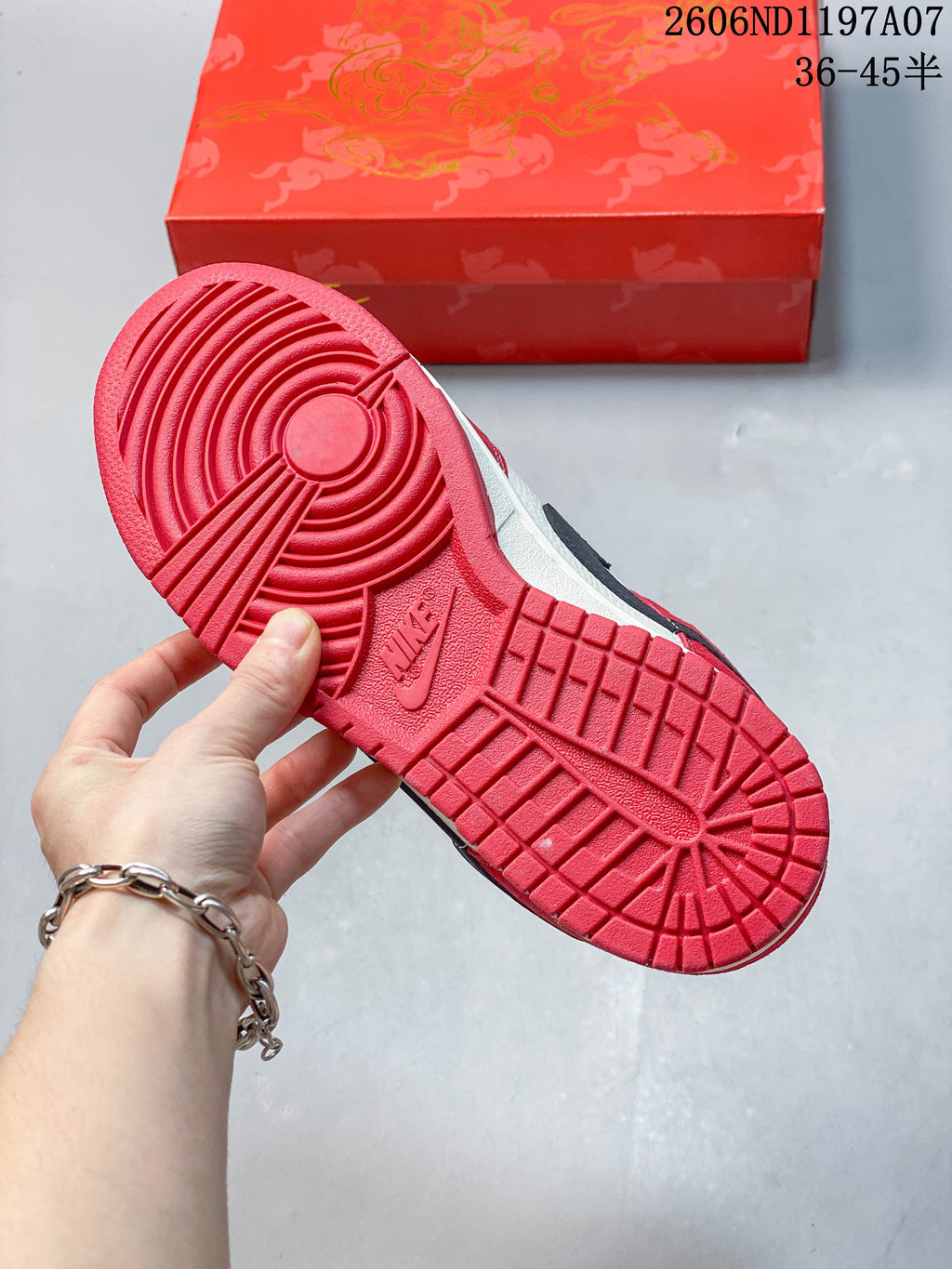 Red outsole showing circular and block tread patterns
