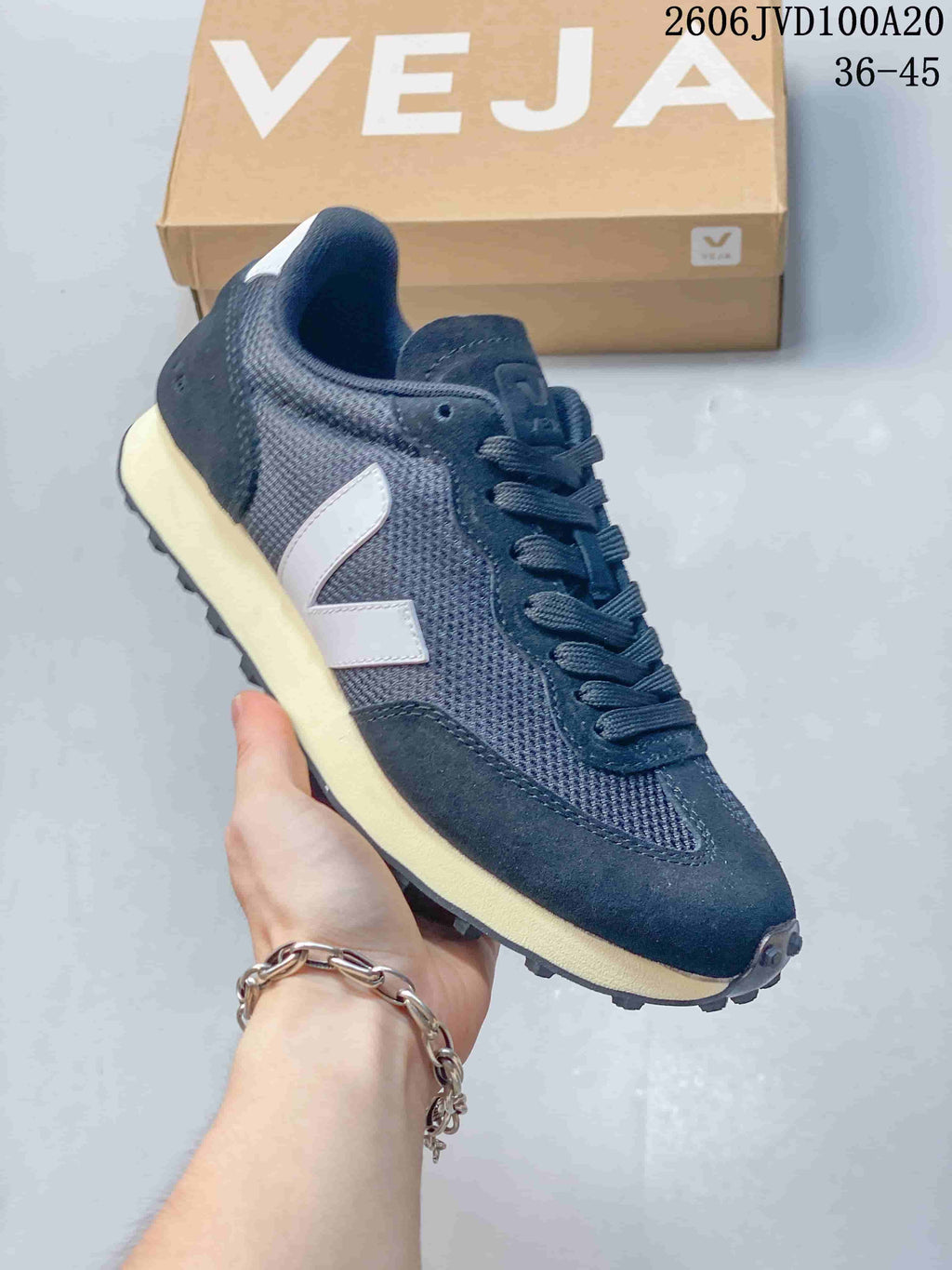 Close-up of a dark navy sneaker with a light V-shaped side logo