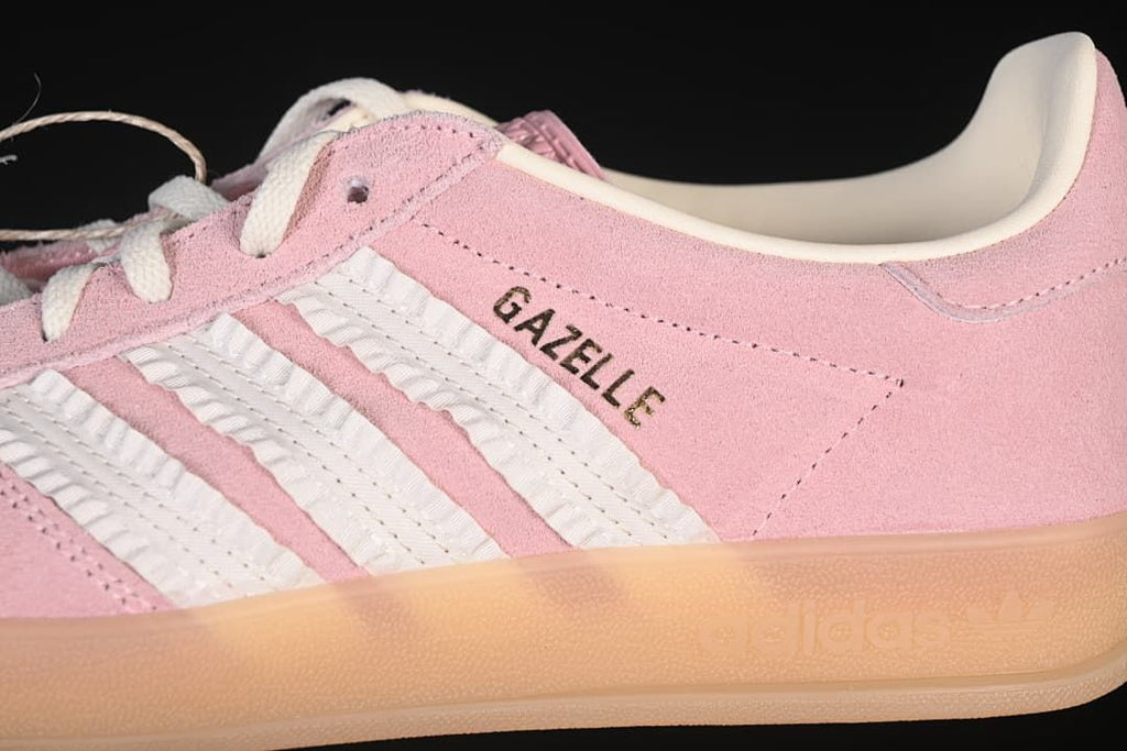 Close-up of the pink upper, white stripes, and Gazelle lettering
