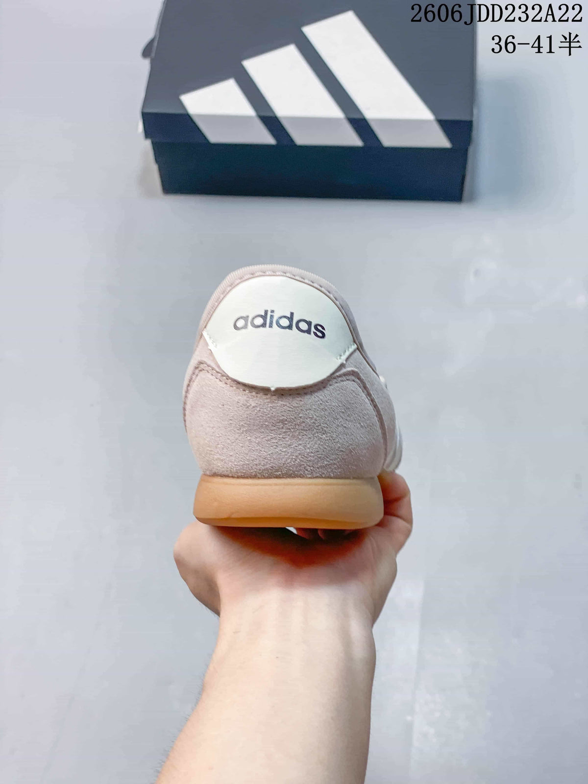 Rear view of the light pink shoe with a branded heel tab