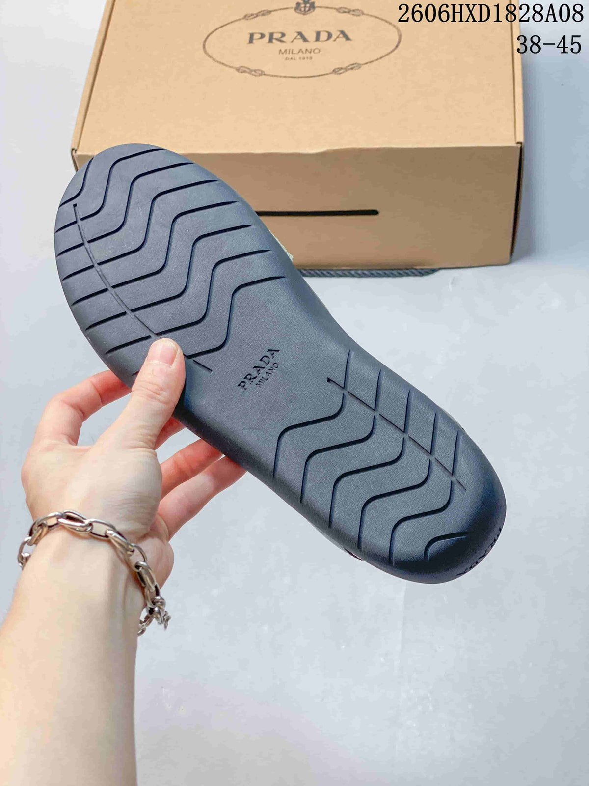 Close-up of the dark sole with molded tread and branding.