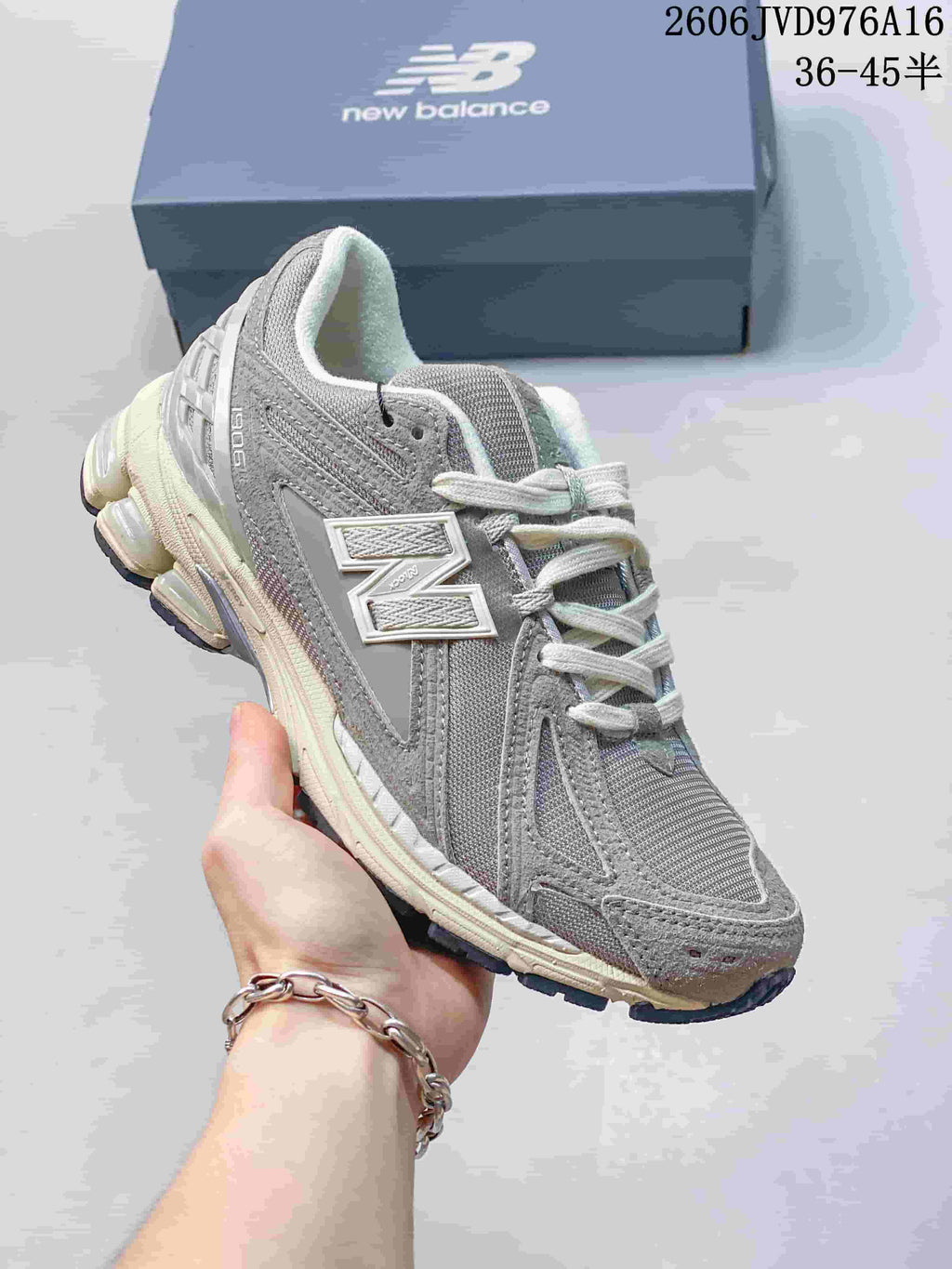 Angled side view of a grey New Balance M1906RKC sneaker.