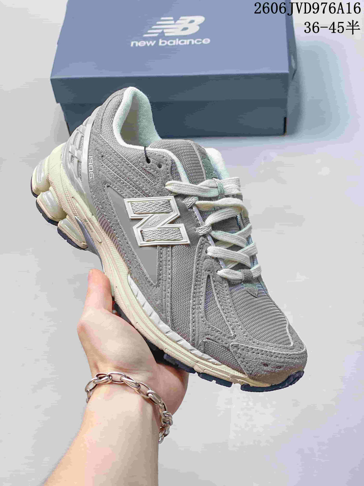 Angled side view of a grey New Balance M1906RKC sneaker.