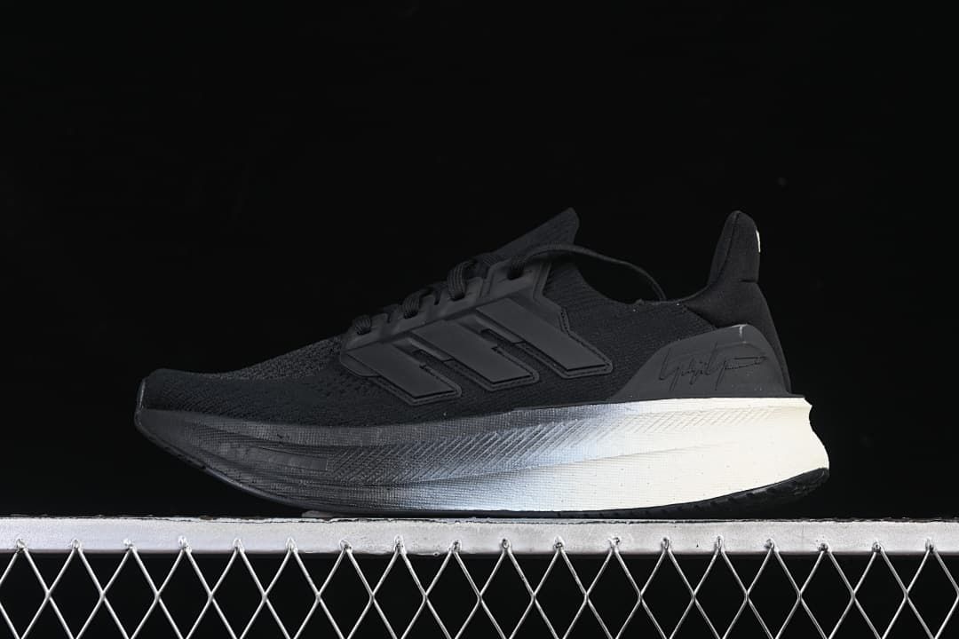 Side view of black Y-3 x adidas Ultraboost 5 sneakers with a contrasting light-colored heel section