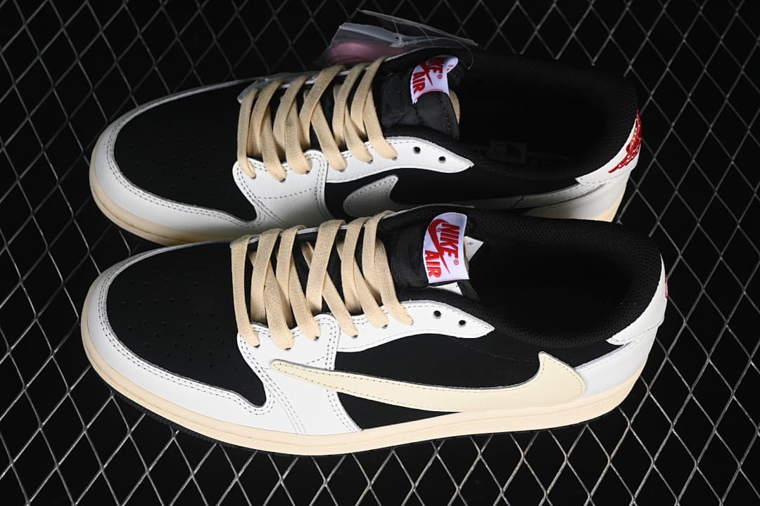 Pair of black and white low-top sneakers with cream oversized Swooshes and laces.