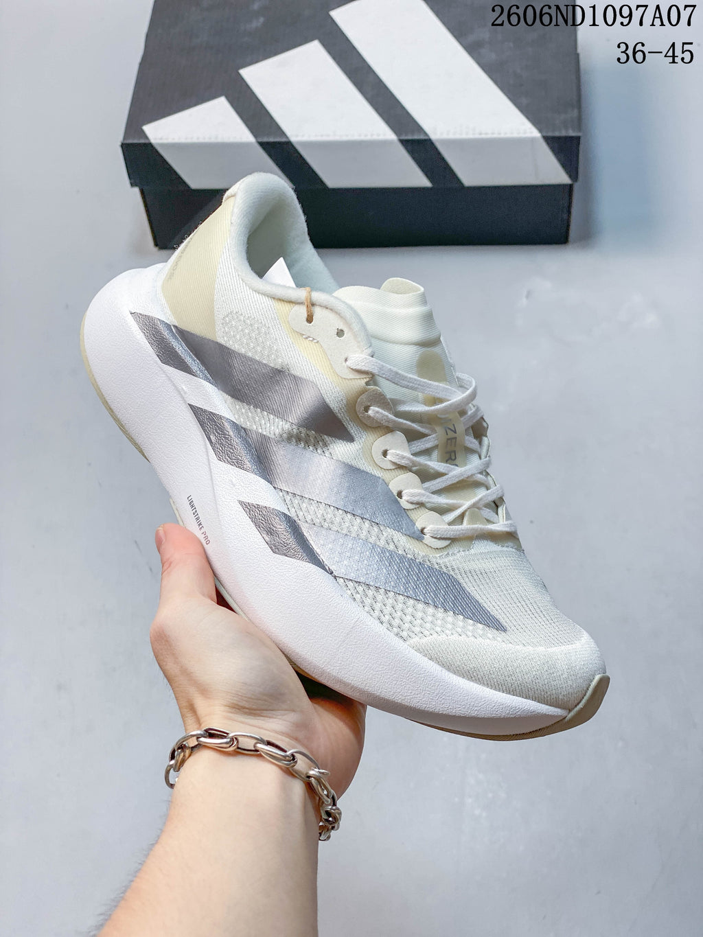Angled side view of the off-white adidas Adizero Evo SL running shoe.