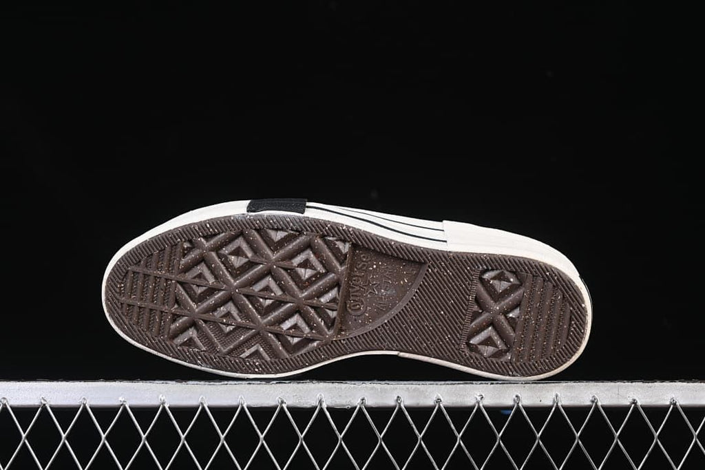 Underside of the sneaker showing the patterned rubber outsole