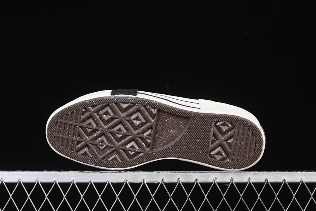 Underside of the sneaker showing the patterned rubber outsole