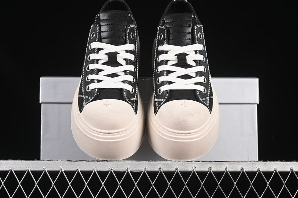 Front view of the pair with light-colored toe caps and thick platform soles.