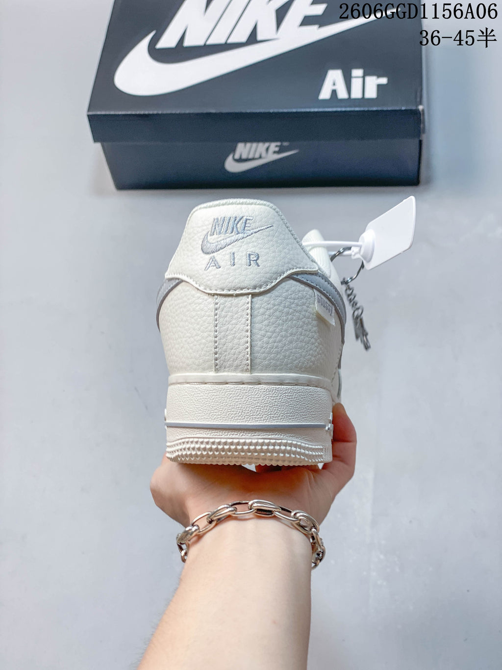 Heel view showing textured ivory and grey panels on the sneaker
