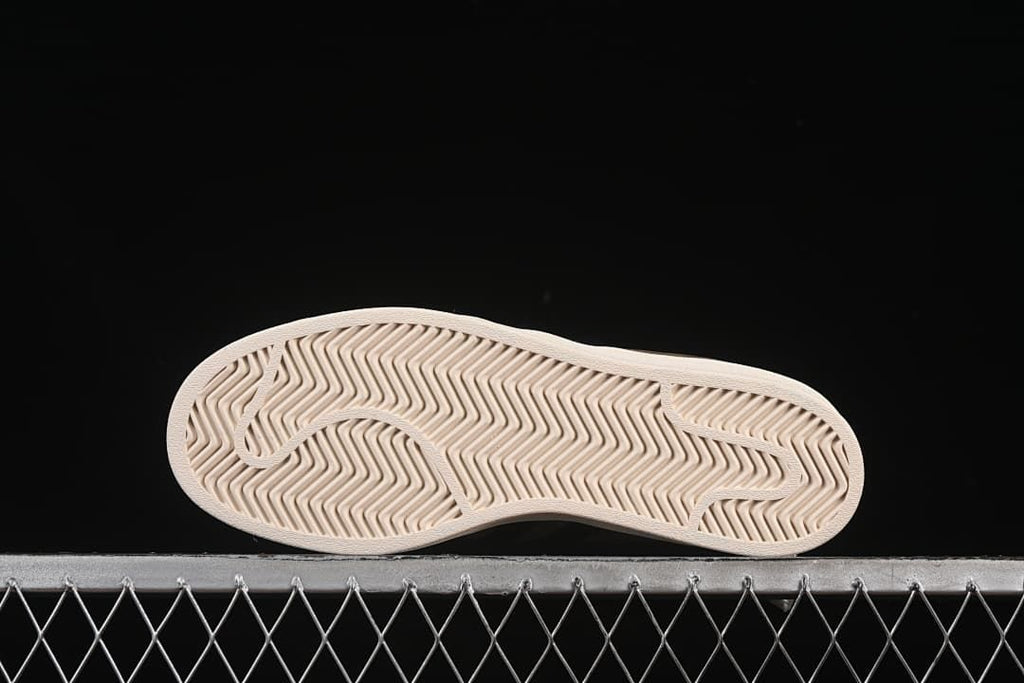 Underside view showing the textured off-white outsoles
