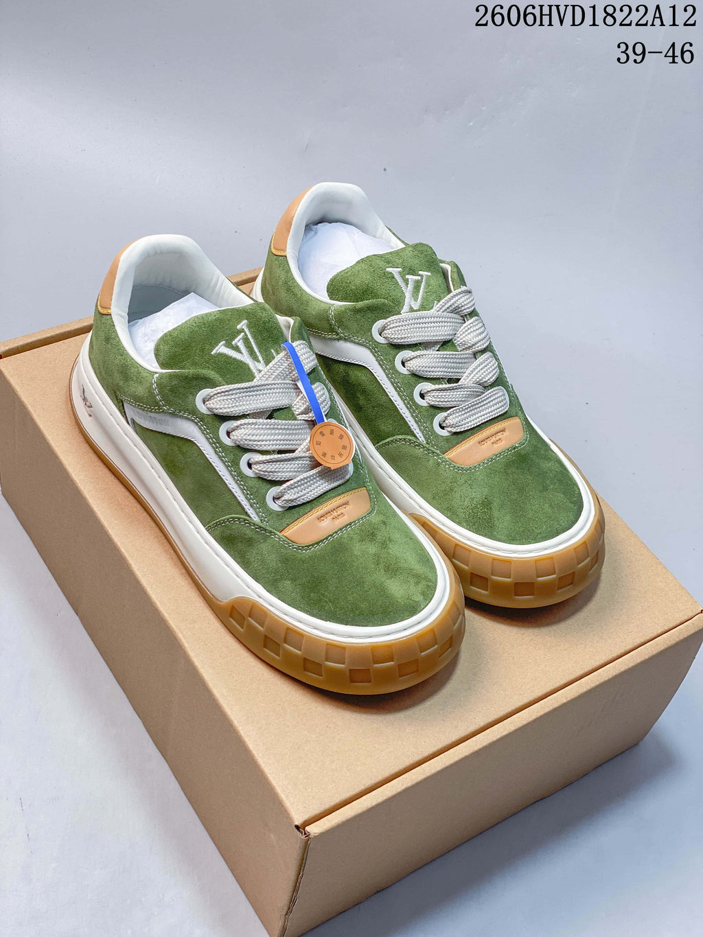Pair of green low-top sneakers with white side panels, wide laces, and gum-colored soles
