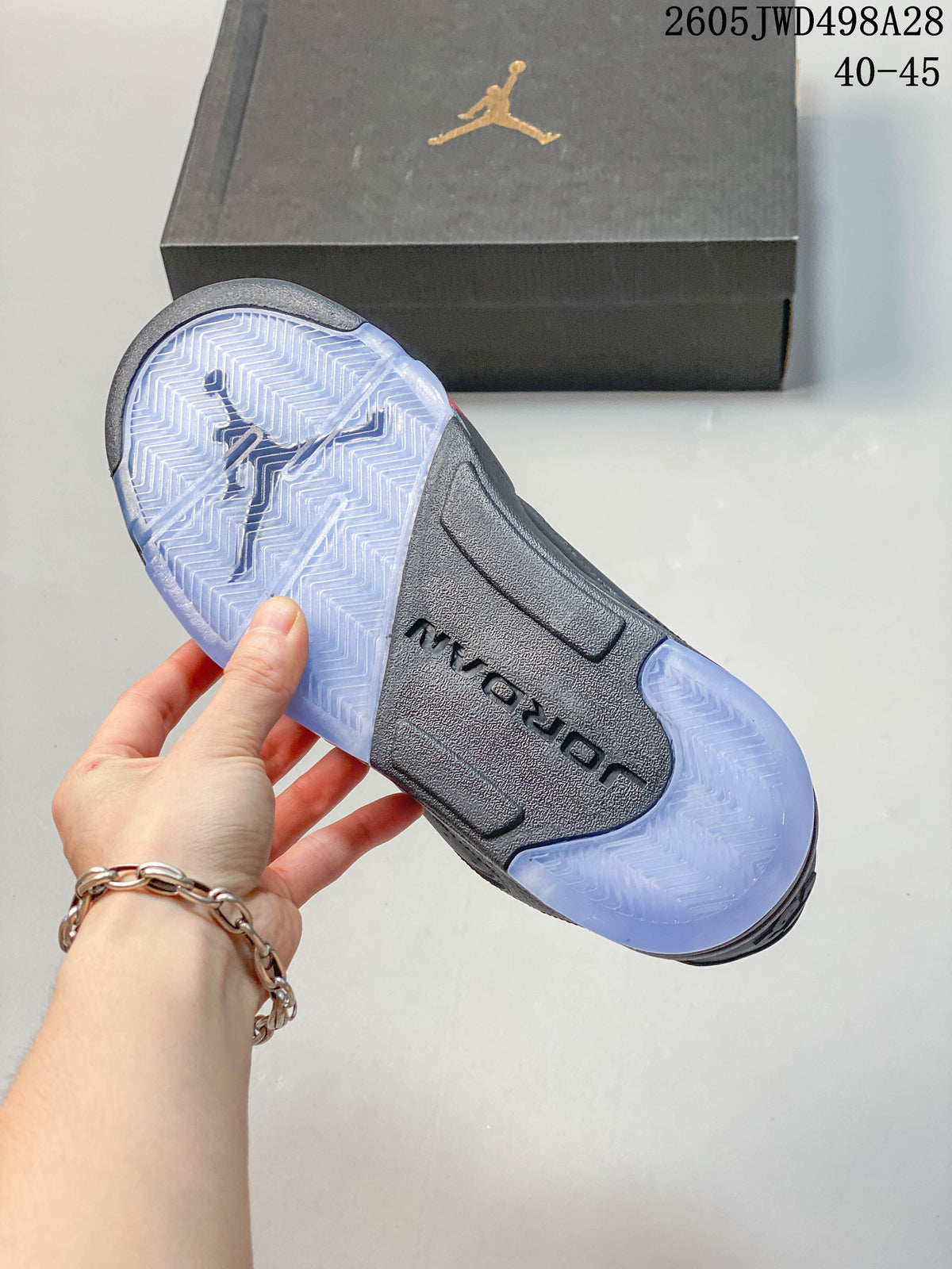 Underside of a Jordan sneaker showing a dark midfoot and translucent-looking outsole sections.