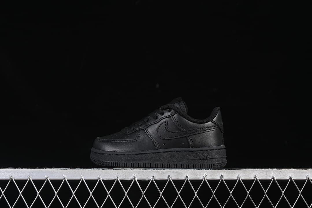 Black Nike Air Force 1 '07 LE kids' low-top sneaker shown in profile