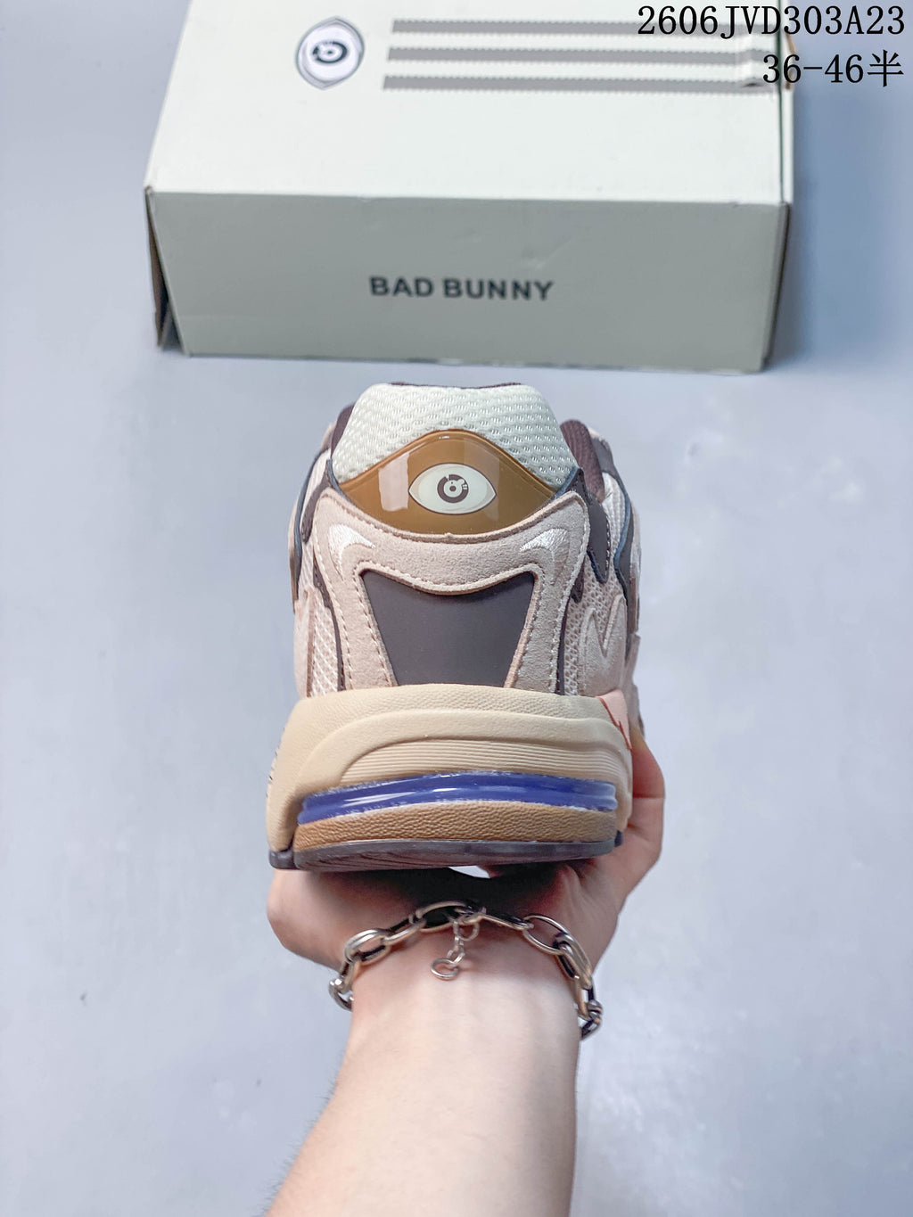 Rear view of the beige and brown sneaker with a purple heel detail