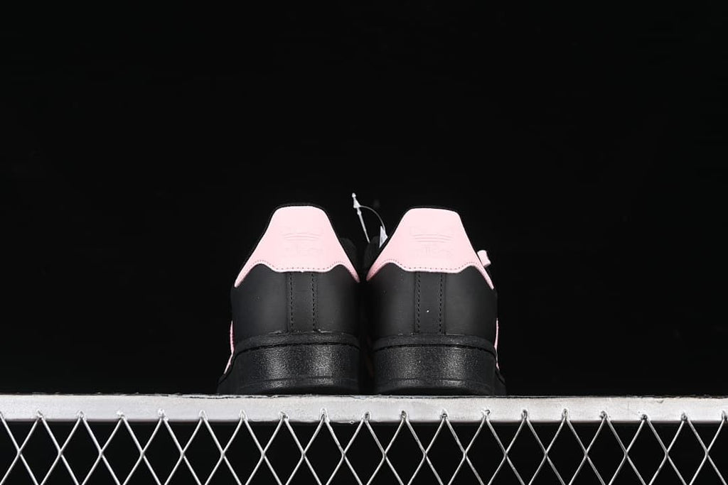 Rear view of both sneakers with contrasting pink heel tabs