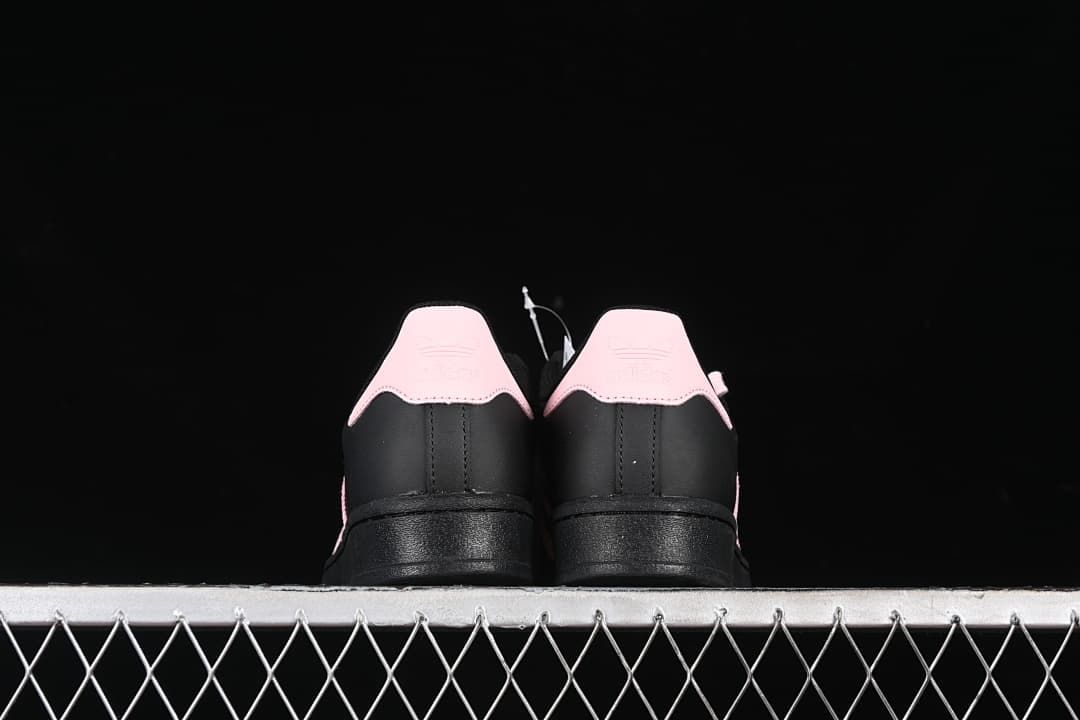 Rear view of both sneakers with contrasting pink heel tabs