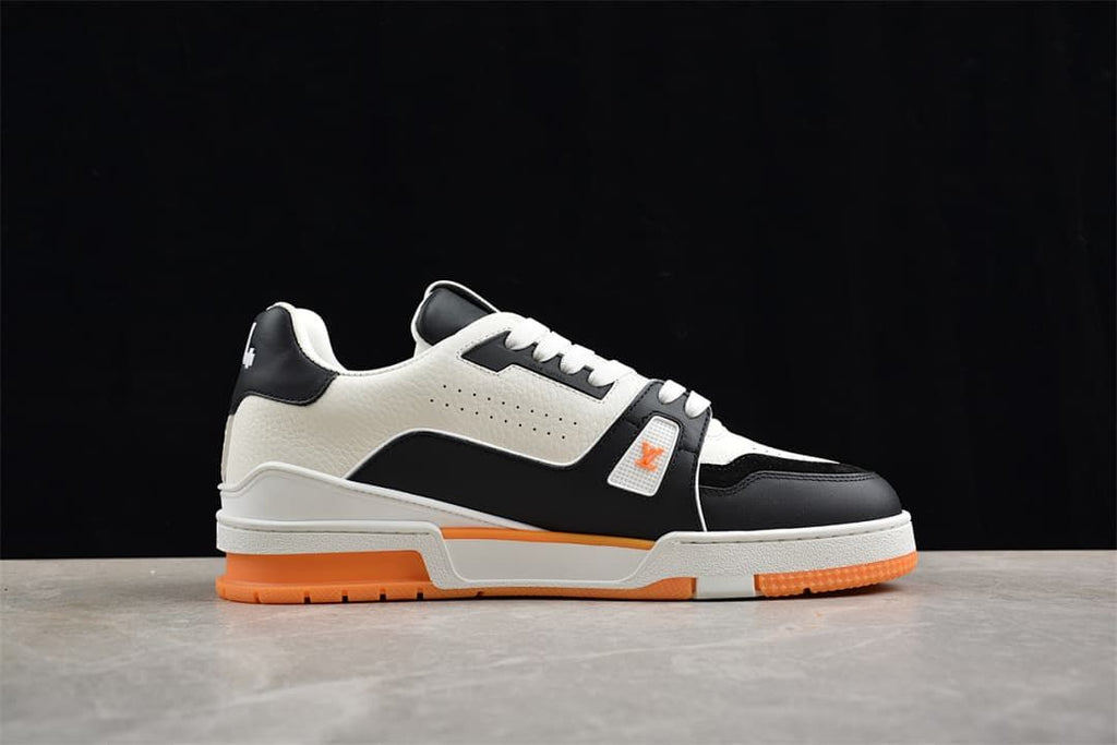 Side profile of the LV Trainer sneaker with white, black, and orange details