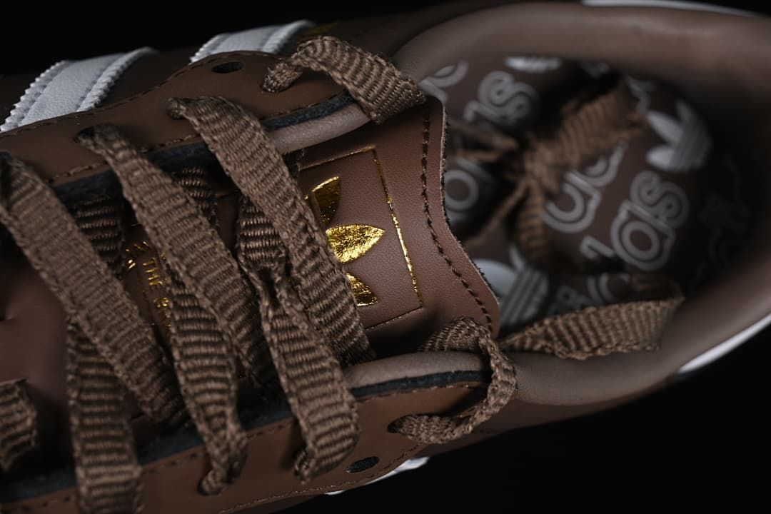 Close-up of brown laces and branded tongue detail