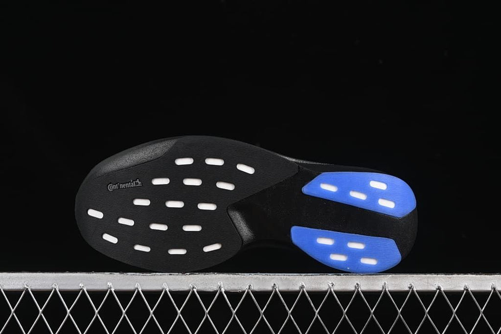 Underside of the shoe showing black and blue outsole sections.