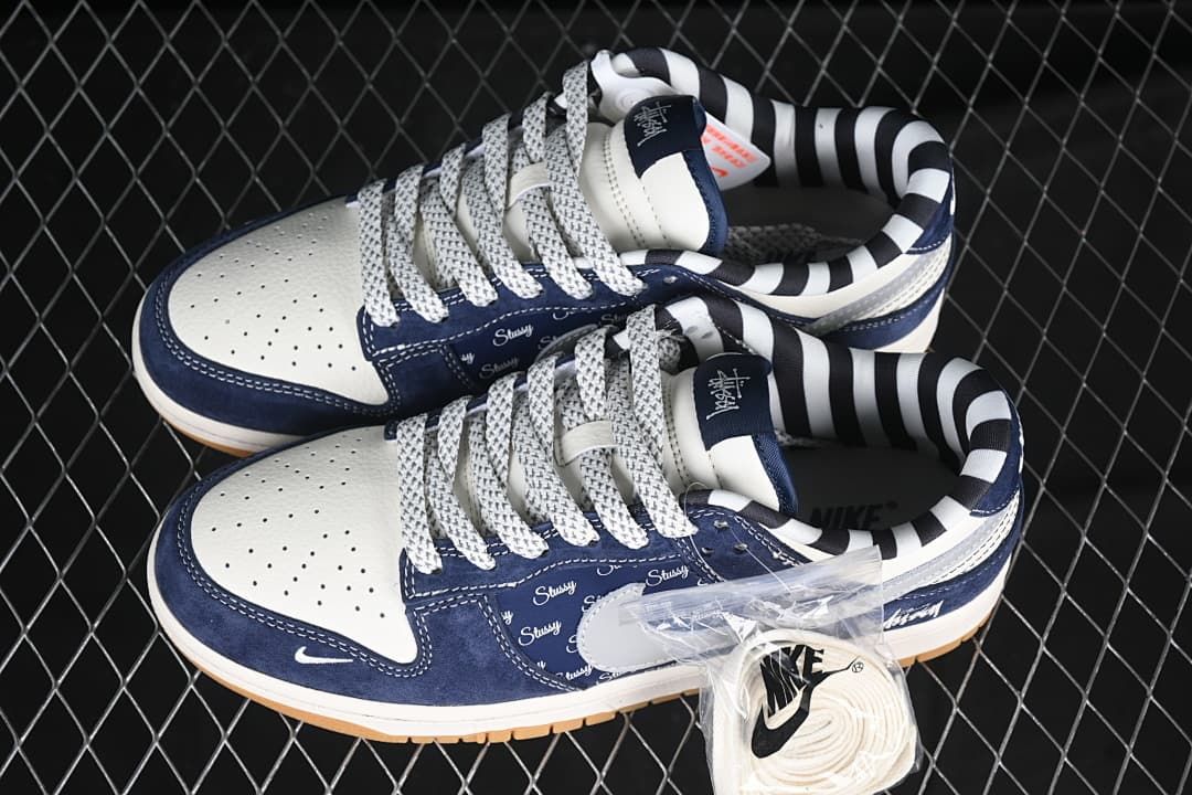 Pair of navy and white sneakers with an extra lace set