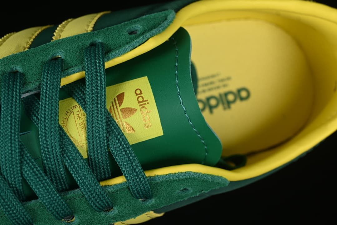 Close-up of green laces, tongue branding and yellow lining