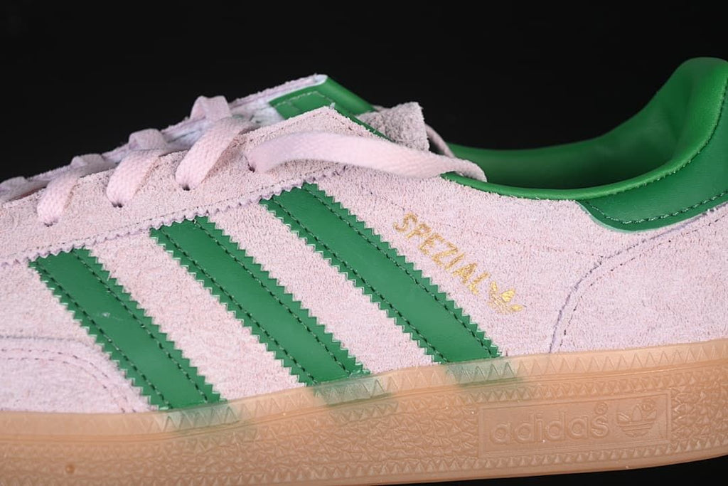 Close-up of the green stripes, gold lettering and pink upper