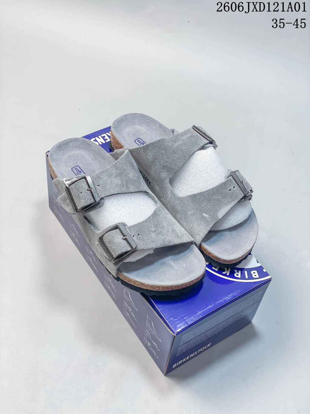 Pair of gray Birkenstock Arizona BS sandals with two adjustable straps, shown on a box