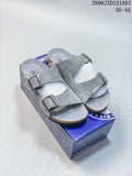 Pair of gray Birkenstock Arizona BS sandals with two adjustable straps, shown on a box